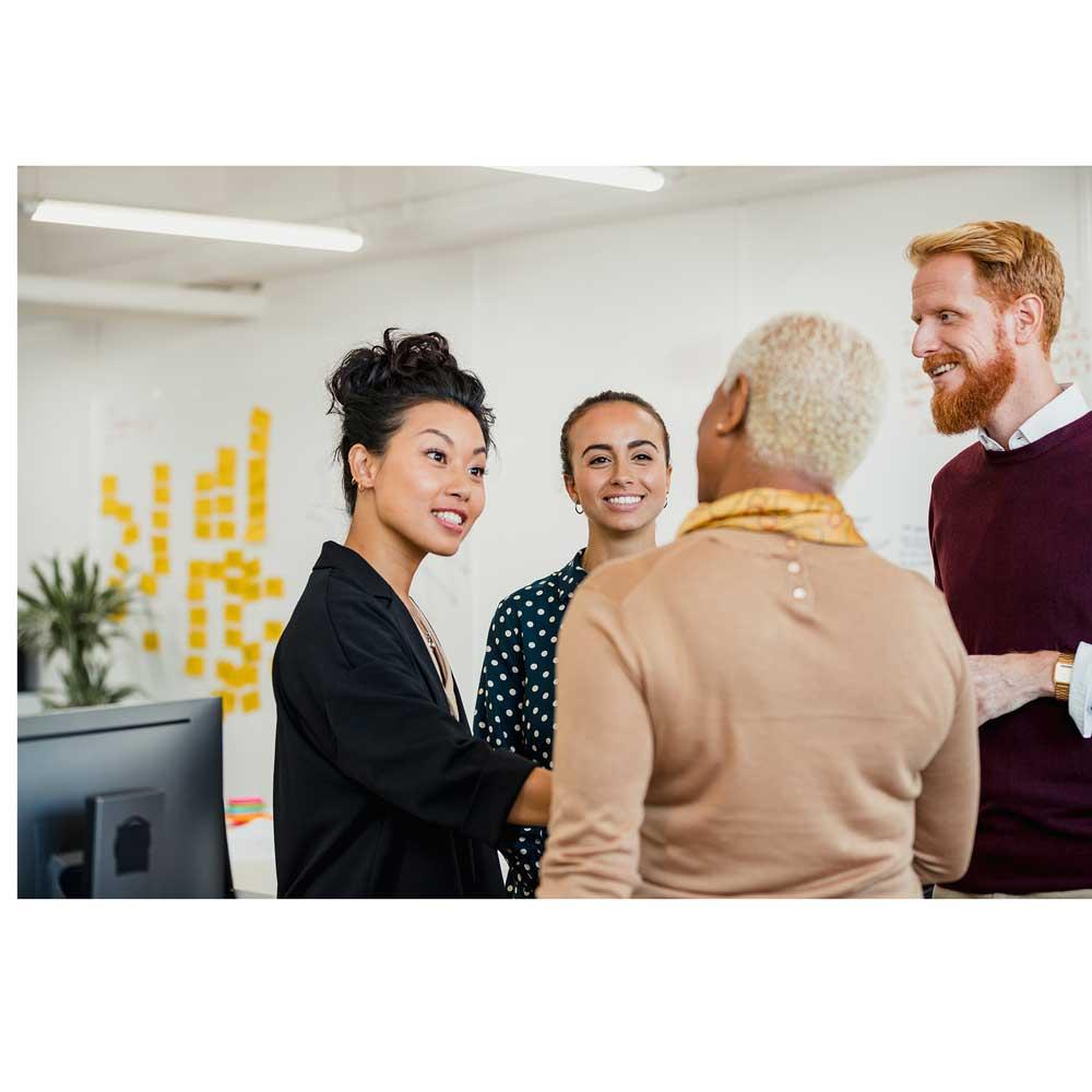 CentralSquare team members standing in an office discussing different public sector software solutions