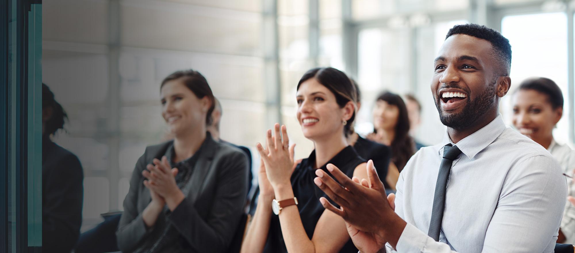 People at a meeting that are excited about CentralSquare public safety, public administration and asset management software solutions