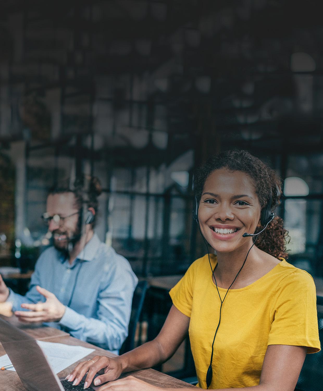 Mobile optimized stock image of a smiling woman wearing a phone headset.