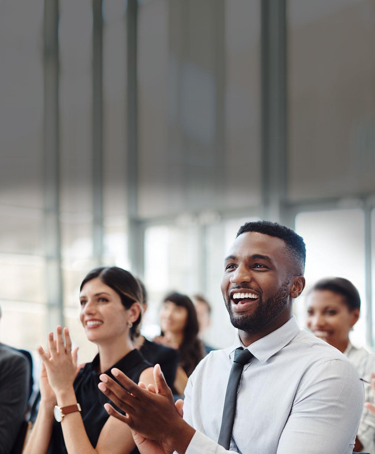 People at a meeting that are excited about CentralSquare public safety, public administration and asset management software solutions