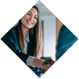 Smiling business professional woman who is shaking hands with someone